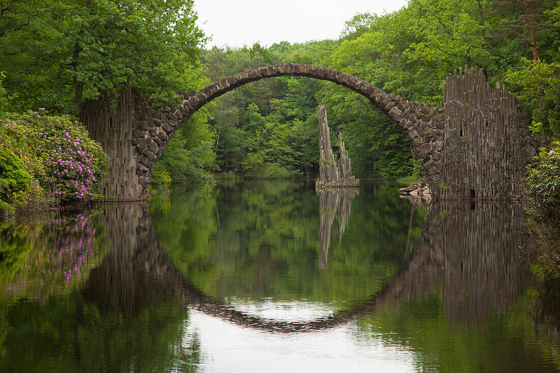 Rakotz bridge reflecting in lake Rakotzsee, Kromlau park, Kromlau, Saxony, Germany, Europe