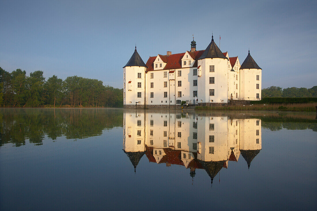 Gluecksburg moated castle reflecting in Flensburg fjord, Baltic Sea, Schleswig-Holstein, Germany, Europe