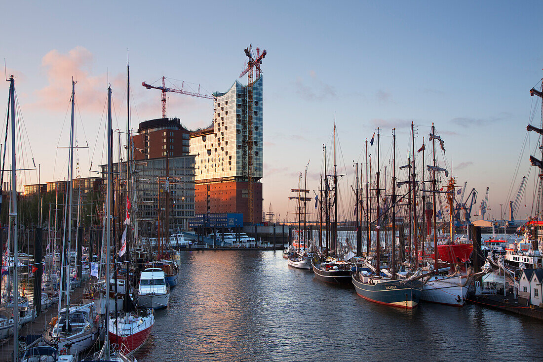 Sailing ships in front of Hafen City and Elbphilharmonie at dusk, Hamburg, Germany, Europe