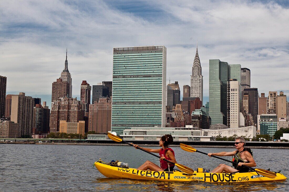 New York - United States, couple kayaking on the East river in front of the skyline of Midtown