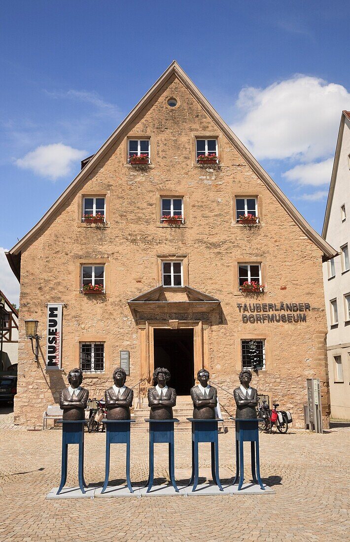 Marktplatz, Weikersheim, Baden-Wurttemberg, Germany, Europe  Sculptures of five women by Guido Messer in front of Tauberland Museum in medieval town on the Romantic Road Romantische Strasse