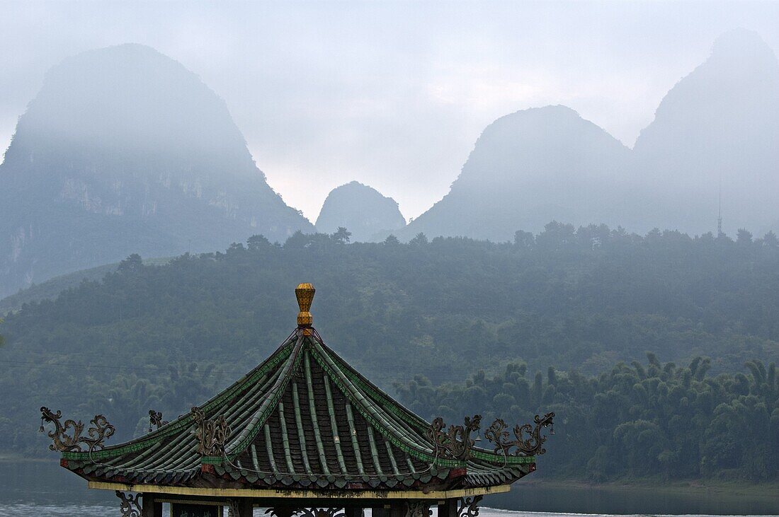Typical Chinese pavilion on the banks of the River Li at sunrise, Yangshuo, Guangxi, China.