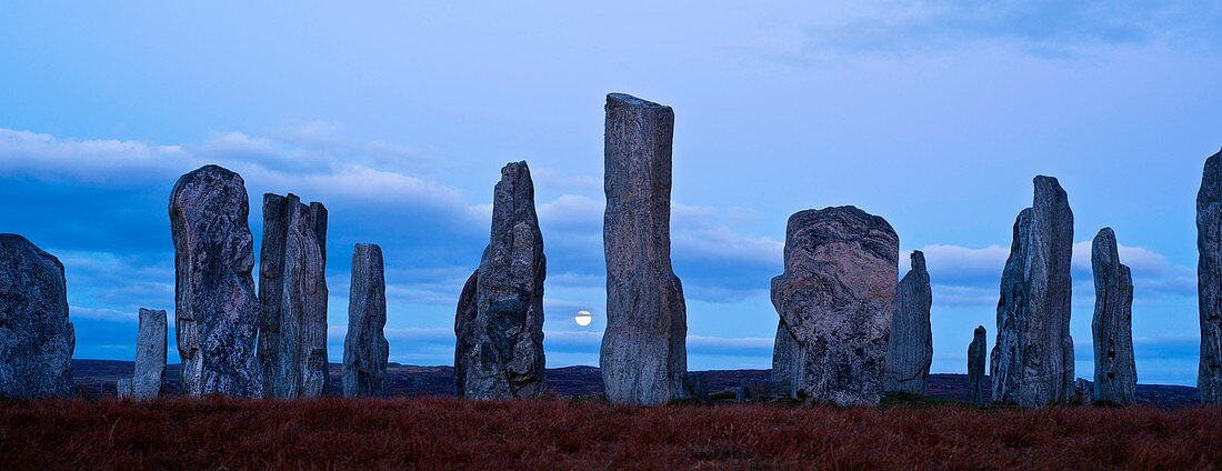 Fullmoon rises behind Callanish standing stones, Isle of Lewis, Outer Hebrides, Scotland