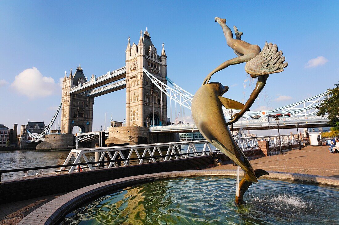 Tower Bridge and Girl Playing With Dolphin statue, London, UK