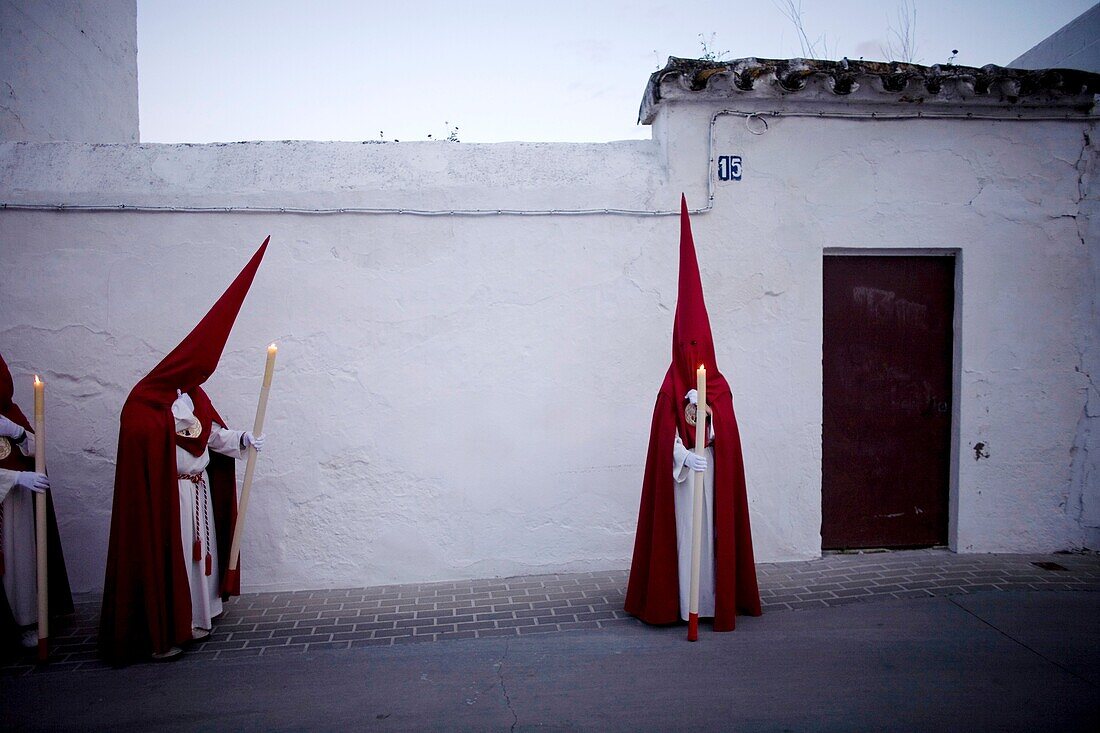 Penitents walk in a street during Easter Holy Week celebrations in Espera village, Cadiz province, Andalusia, Spain.