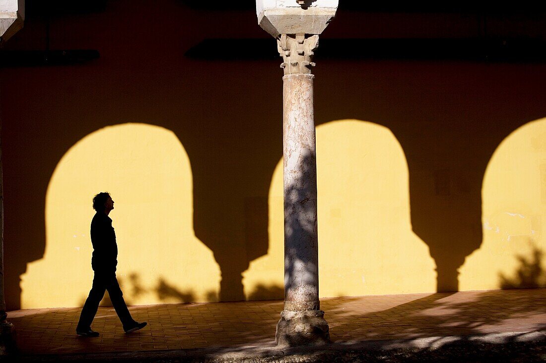 A tourist walks in the Mosque and Cathedral of Cordoba, Andalusia, Spain.
