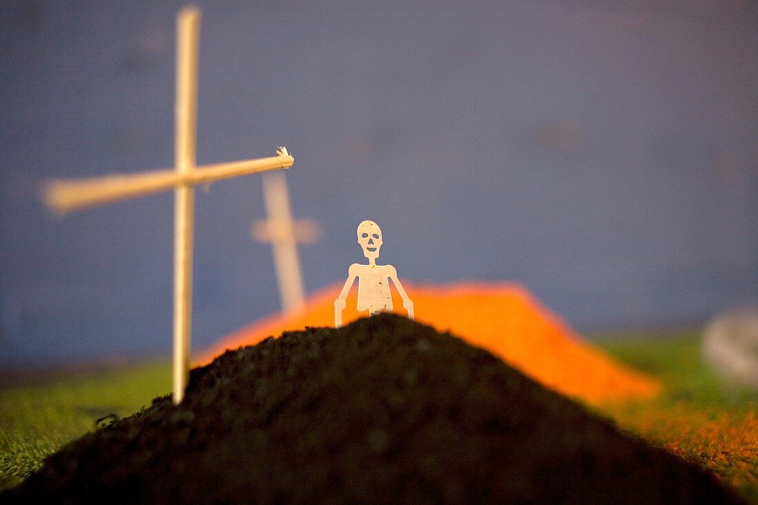 A paper skeleton decorates a tomb made of painted sand and wooden crosses as part of an altar ahead of Day of the Dead celebrations in Mexico City.