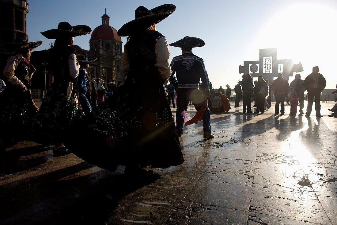 Pilgrims dance outside the Our Lady of Guadalupe Basilica in Mexico City, December 8, 2010  Hundreds of thousands of Mexican pilgrims converged on the Basilica, bringing images to be blessed, as processions filled the streets for the feast day of Our Lady