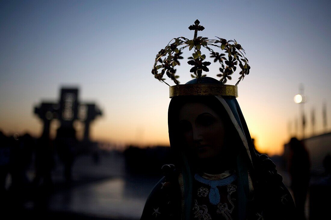 A statue of Our Lady of Guadalupe is silhouetted against the sunrise in Mexico City, December 10, 2010  Hundreds of thousands of Mexican pilgrims converged on the Basilica, bringing images to be blessed, as processions filled the streets for the feast day