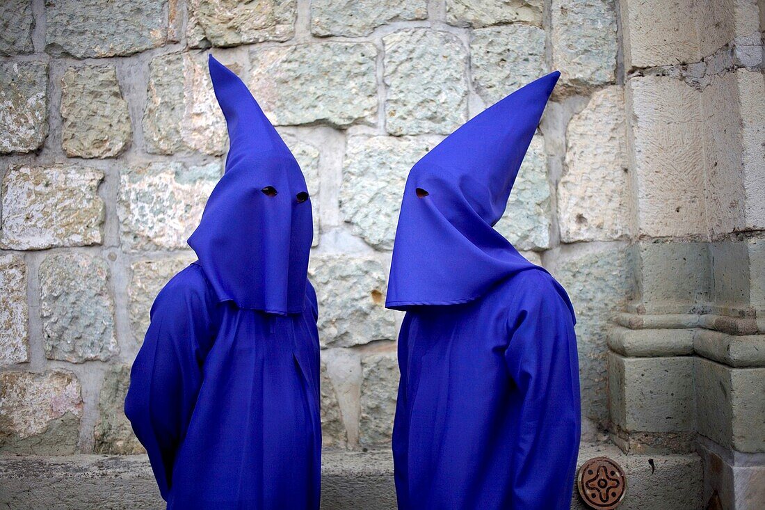 Penitents speak before a holy week procession in Oaxaca, Mexico, April 10, 2009