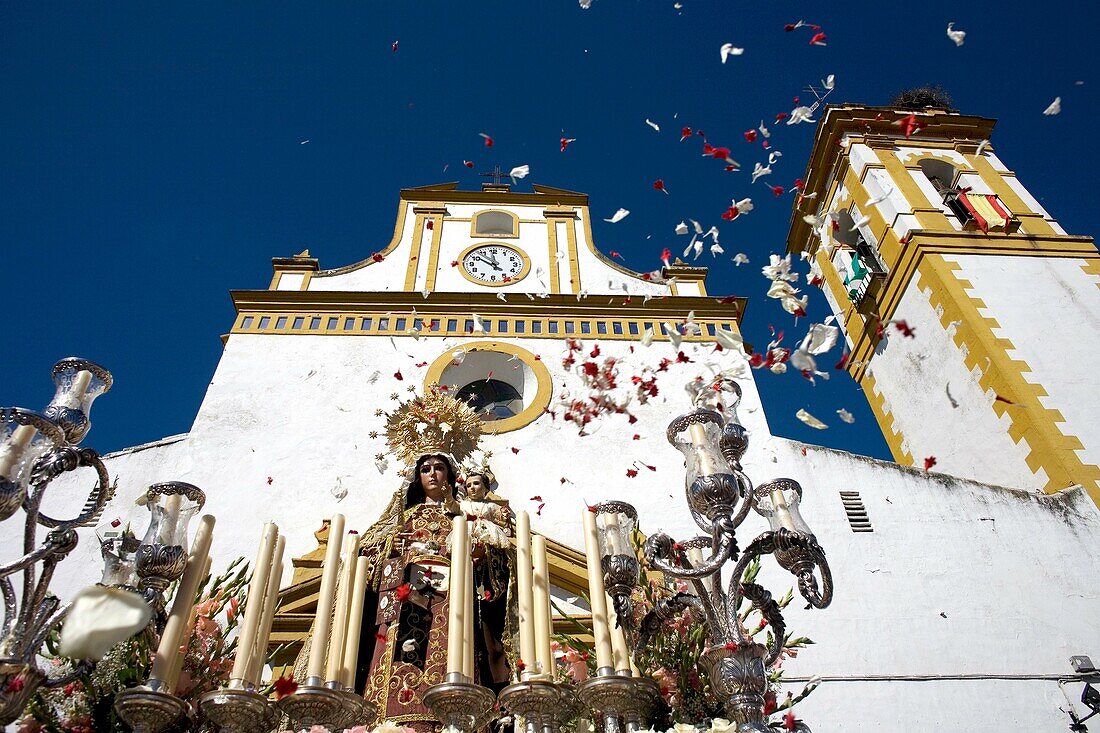 People throw flowers petals toward a wooden statue of the Virgin Carmen is publicly displayed during a Holy Week procession in the town of Prado del Rey in southern Spain´s Cadiz Sierra region in Andalucia, April 4, 2008  Easter processions in Andalucia d