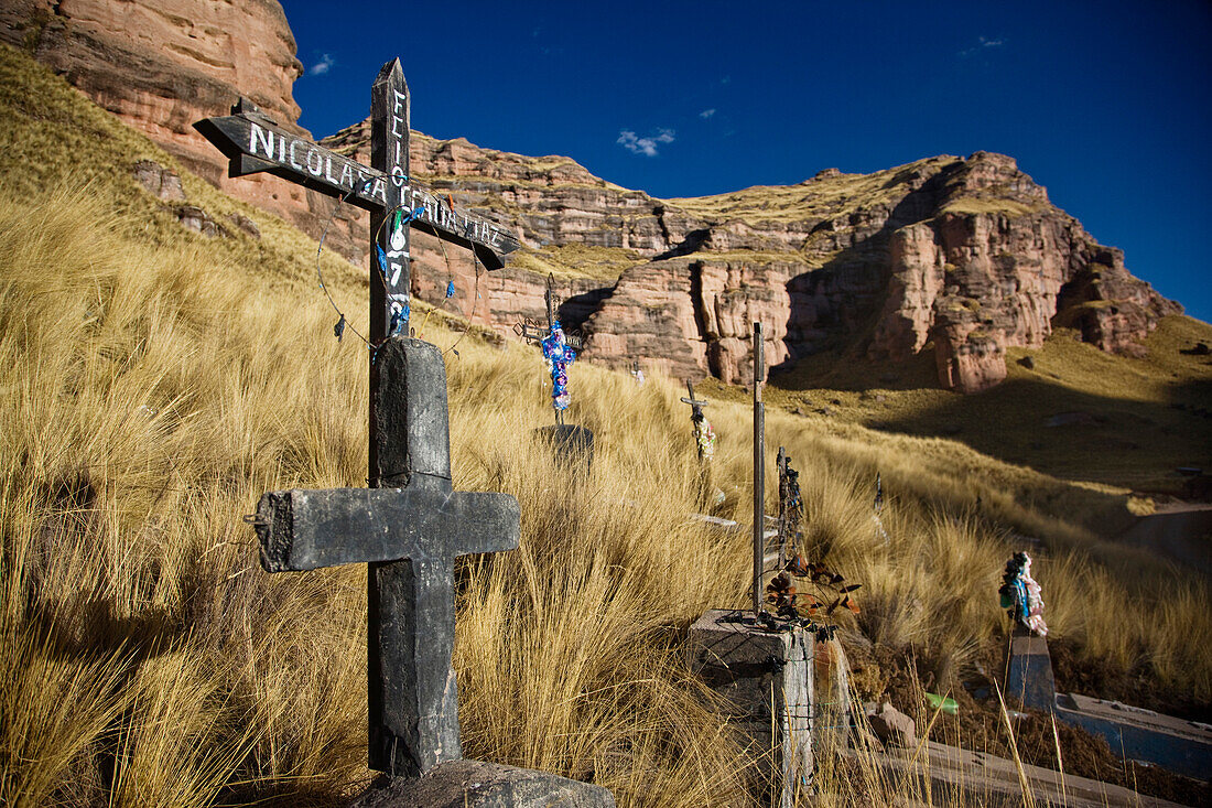 Grave sites near Ayaviri, a town and centre for Roman Catholic worship. Crosses and graves in a Christian burial site. Cliffs., Ayaviri, Peru