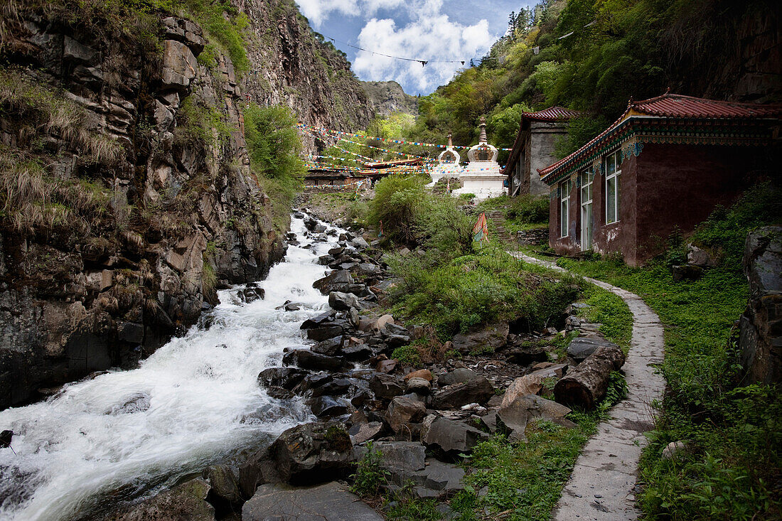 Kandru Village, a mountain village. Valley. A river with white water flowing over the rocks. Houses and path., Sichuan Tibet