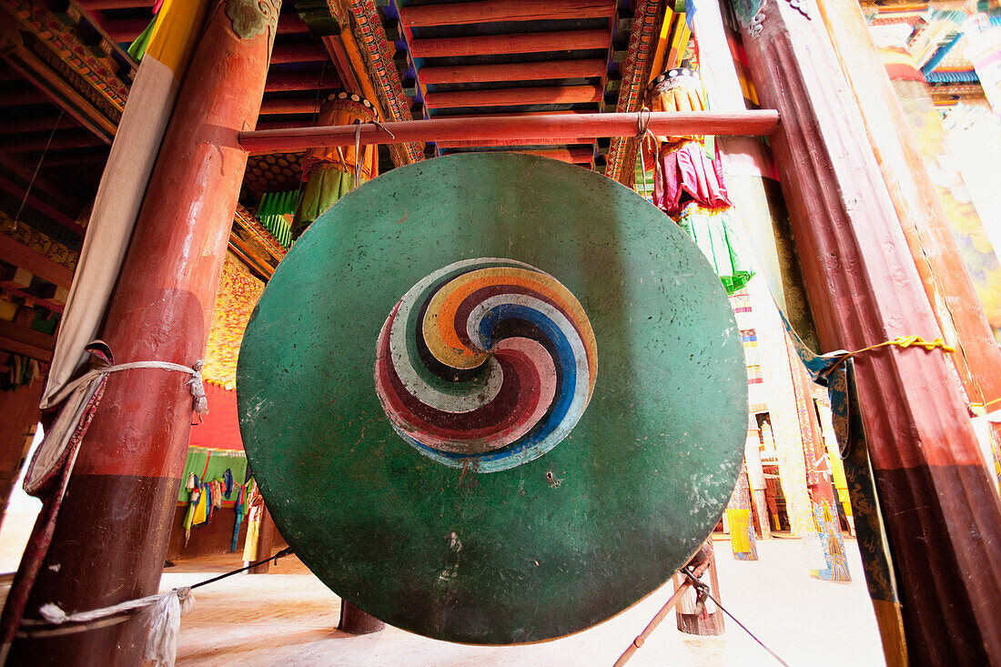 Derge Gonchen Gompa. The Sakya Monastery, being refurbished and rebuilt. A decorated brass gong. Prayer Hall., Sichuan Tibet