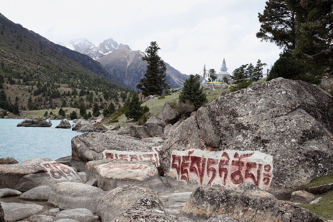 Giant Mani rocks beside the Yihun Lhatso, a holy alpine lake in a valley beside the road between Manigango and Dege. Inscriptions and prayers, roadside shrine., Sichuan Tibet