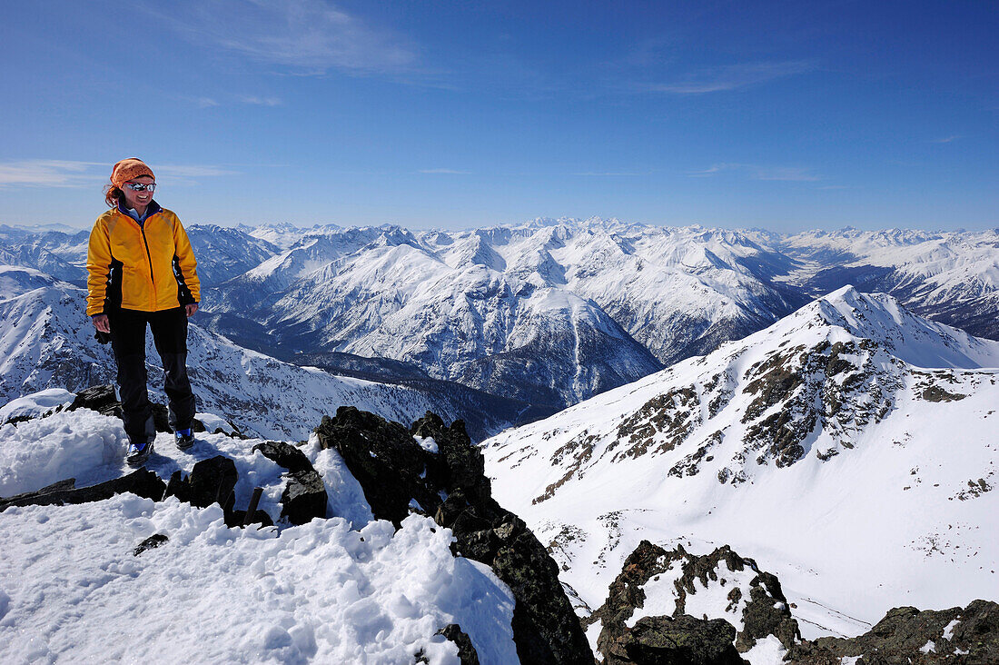 Woman backcountry skiing, ascending to summit of Piz Nuna, Swiss National Park, Piz Nuna, Engadin, Grisons, Switzerland