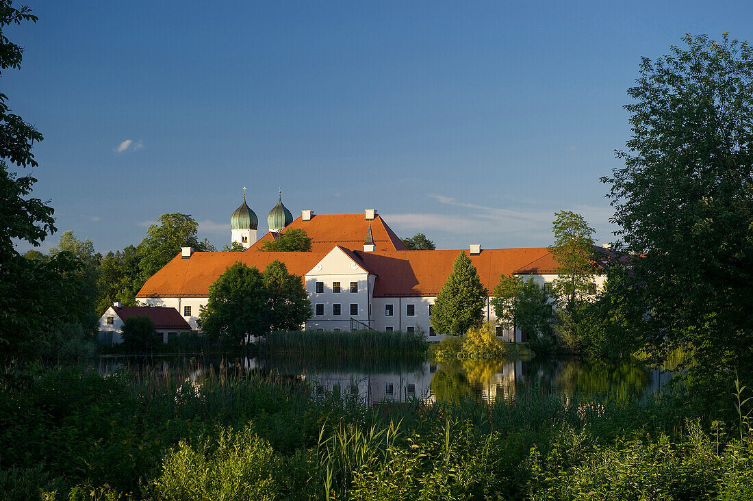 Seeon Abbey reflecting in the lake, Seeon, Chiemgau, Bavaria, Germany