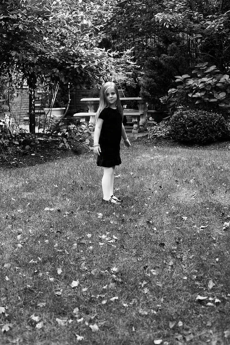 Young Girl in Dress Standing in Yard, Portrait