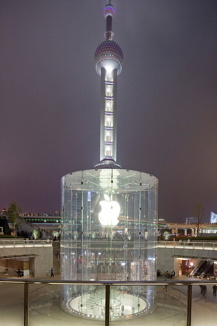 Glass stairway to Apple store in front of Oriental Pearl Tower at night, Pudong, Shanghai, China, Asia