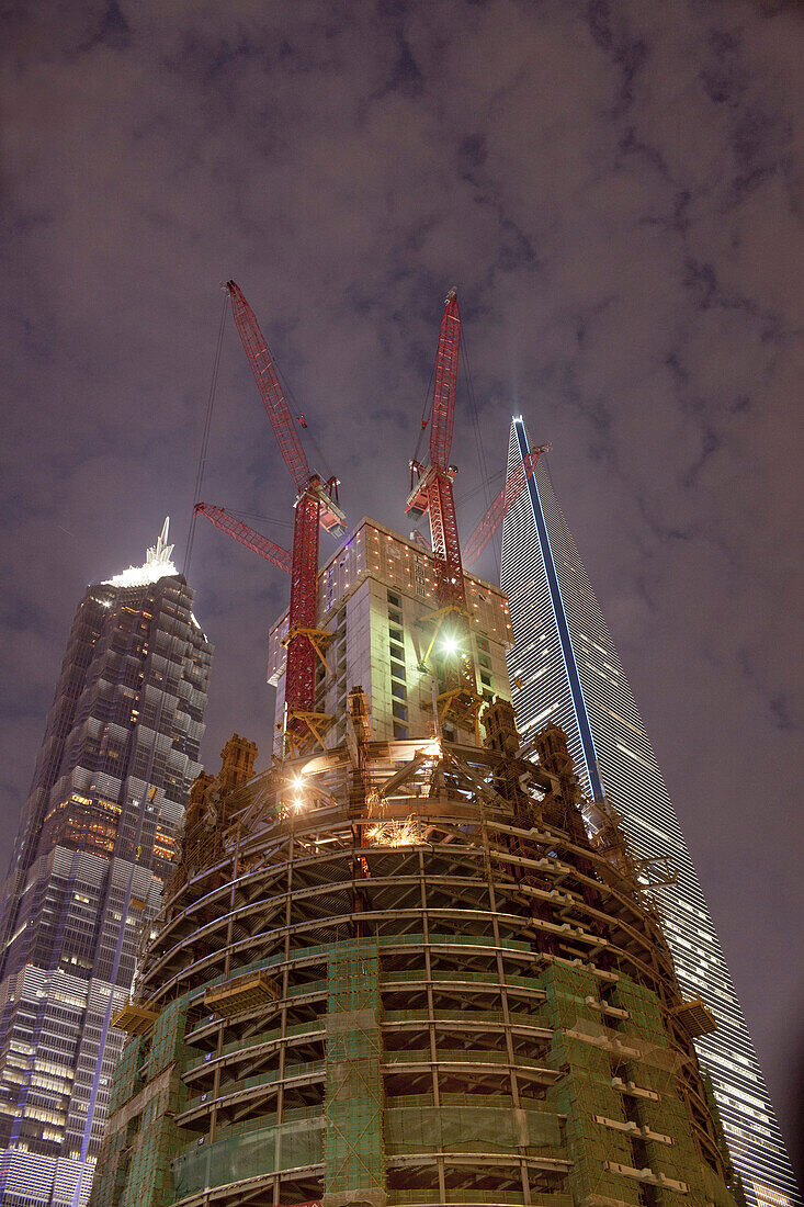 Construction site of Shanghai Tower next to Shanghai World Financial Center and Jin Mao Tower at night, Pudong, Shanghai, China, Asia