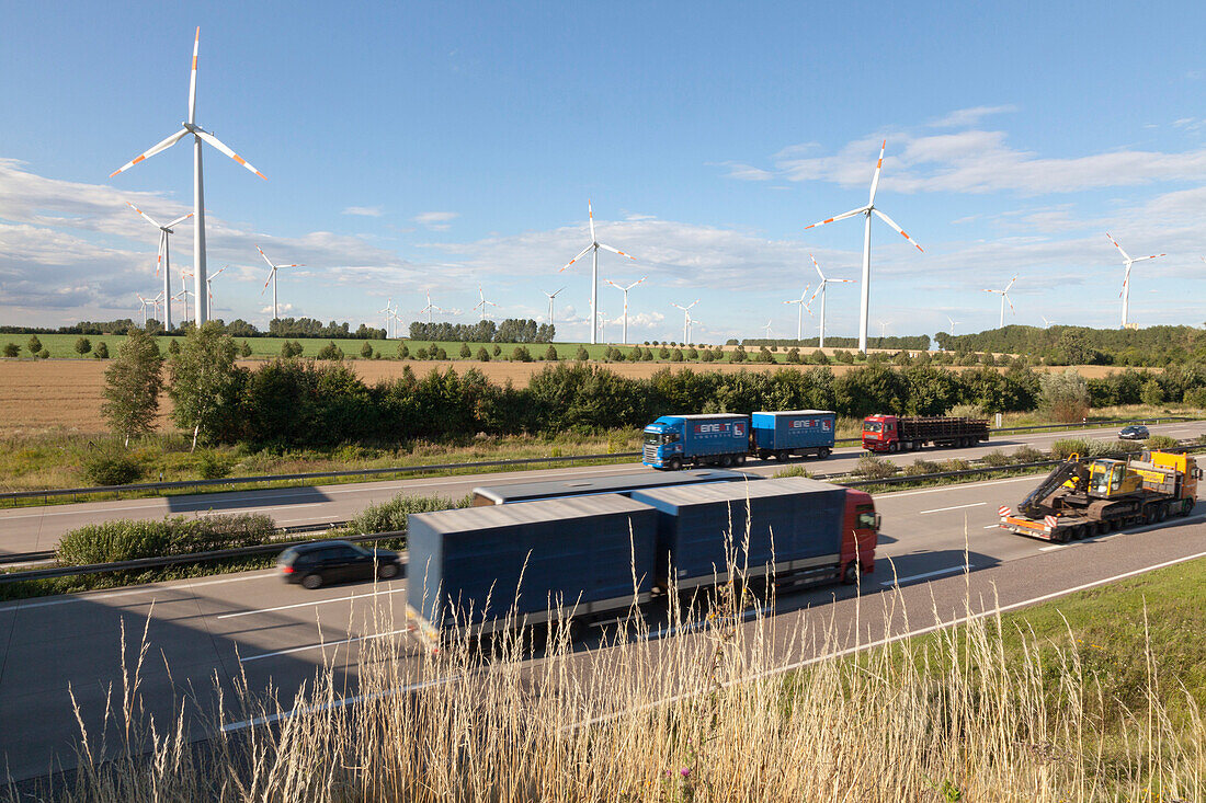 Wind turbines along the A2 Autobahn in the direction of Berlin with traffic, Magdeburg, Lower Saxony, Germany