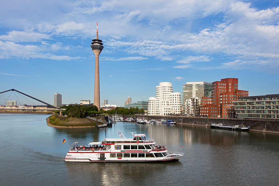 Excursion boat at media harbour, view to Rhine tower and Neuer Zollhof, Duesseldorf, North Rhine-Westphalia, Germany, Europe