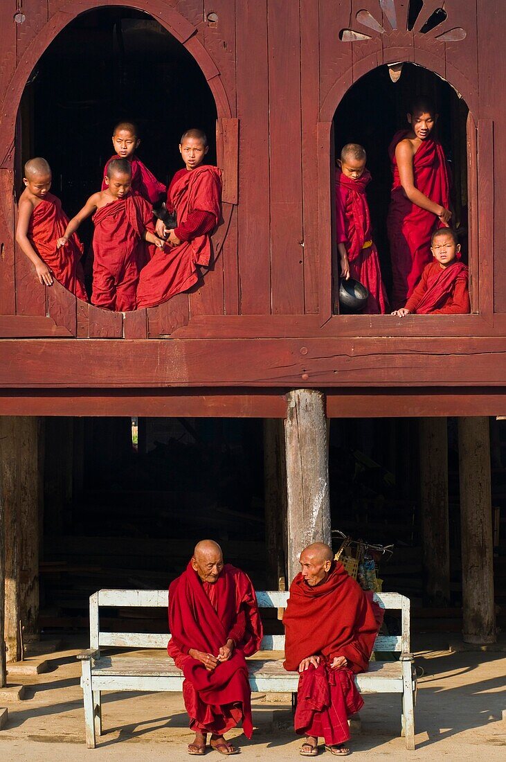 Myanmar (Burma), Shan State, Shwe Yan Pye, Shwe Yan Pye monastery, bonzes like to look at the oval windows of the temple as the monks U Taw Na and U Thumana talk together