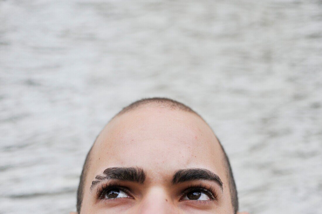 Close-up portrait of a young man looking up