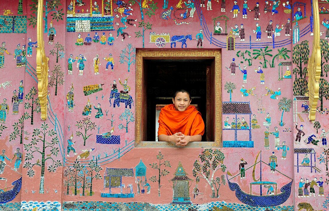 Asia, Southeast Asia, Laos, Wat Xieng Thong temple, monk looking out of a window