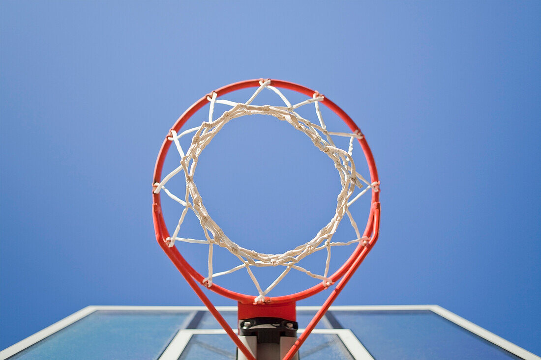 Basketball hoop, metal ring and netting, viewed from below. Green backboard. Sports court in Thousand Oaks, California, USA., Basketball hoop and net.