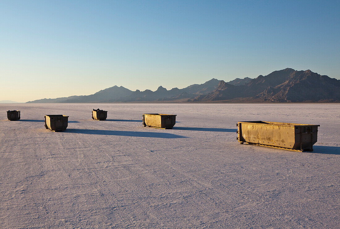 Large garbage  and recycling containers on Bonneville Salt Flats in  Speed Week, an annual amateur auto racing event. A row of four large containers for trash. Utah, USA., Bonneville Salt Flats in Speed Week