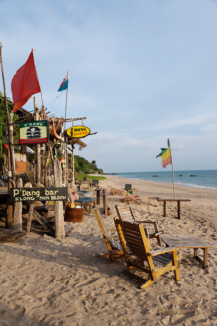 A resort and holiday destination in the Andaman sea. The beach and the shoreline. Waves. The Lanta Miami Hotel beach cabins., Ko Lanta Island, Krabi Province, Thailand.