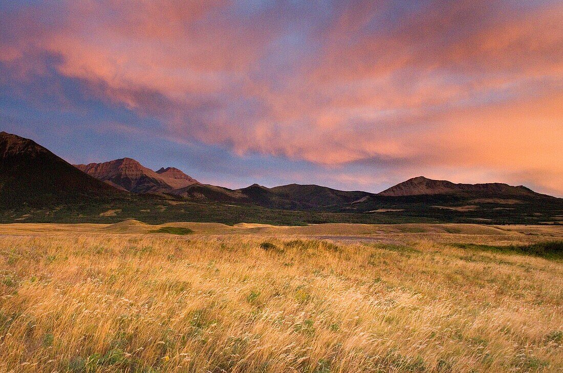 Colorful sunrise over the plains and Rocky Mountains at Waterton Lakes National Park Alberta Canada
