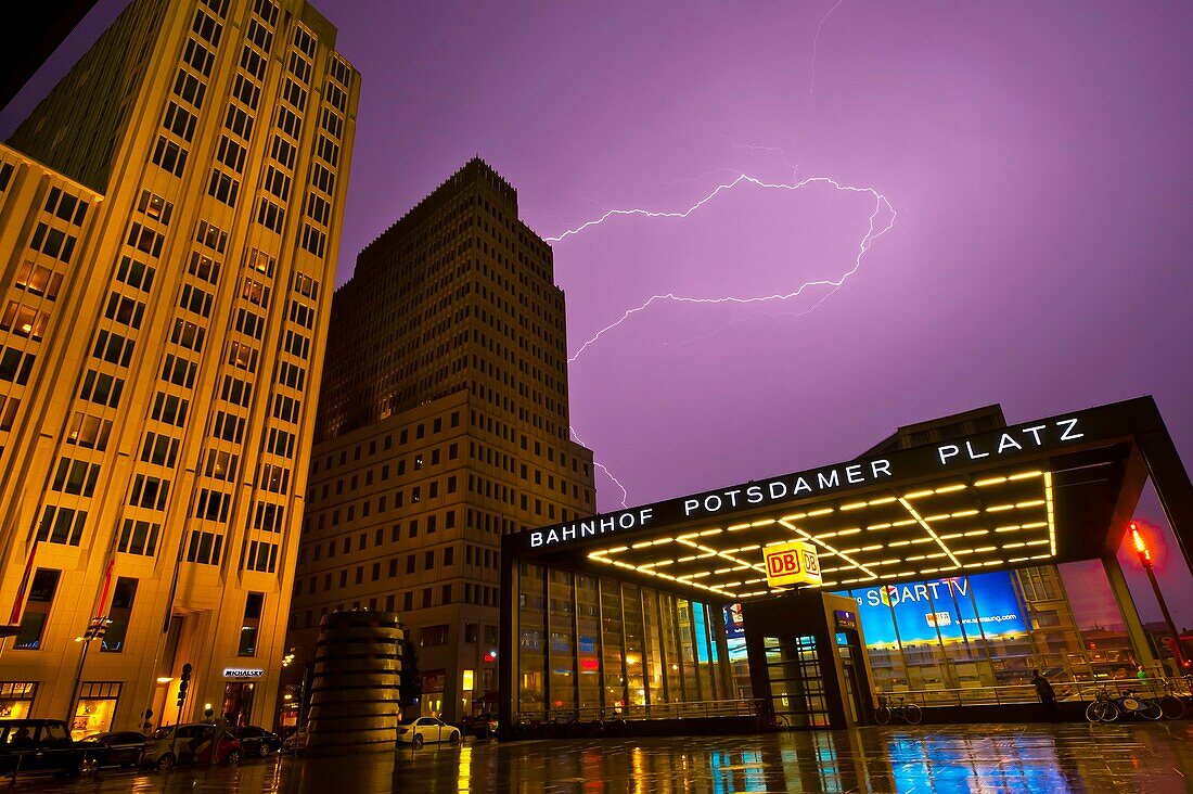 Lightning over the Bahnhof Potsdamer Platz and the Ritz-Carlton Hotel on left, Mitte, Berlin, Germany