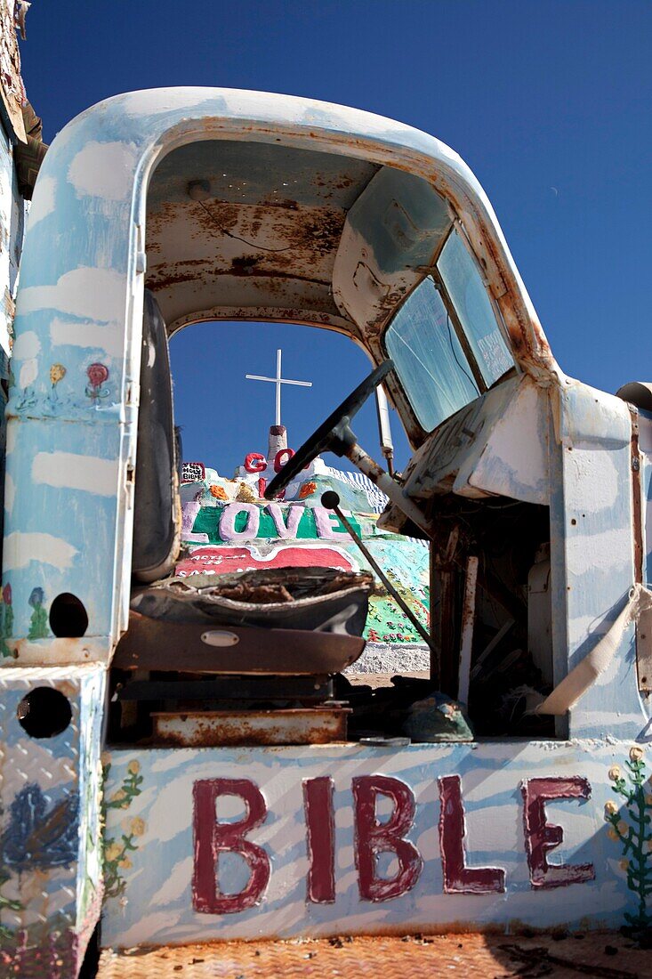 Niland, California - Salvation Mountain, a desert hillside covered with religious messages, created by Leonard Knight  An old truck is painted with religious slogans