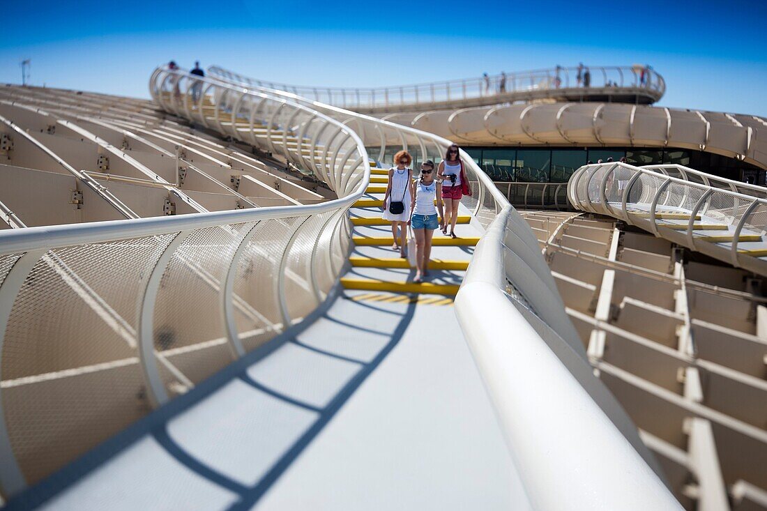 People on the walkway on the top of Metropol Parasol structure, Seville, Spain  Tilted lens used for shallower depth of field