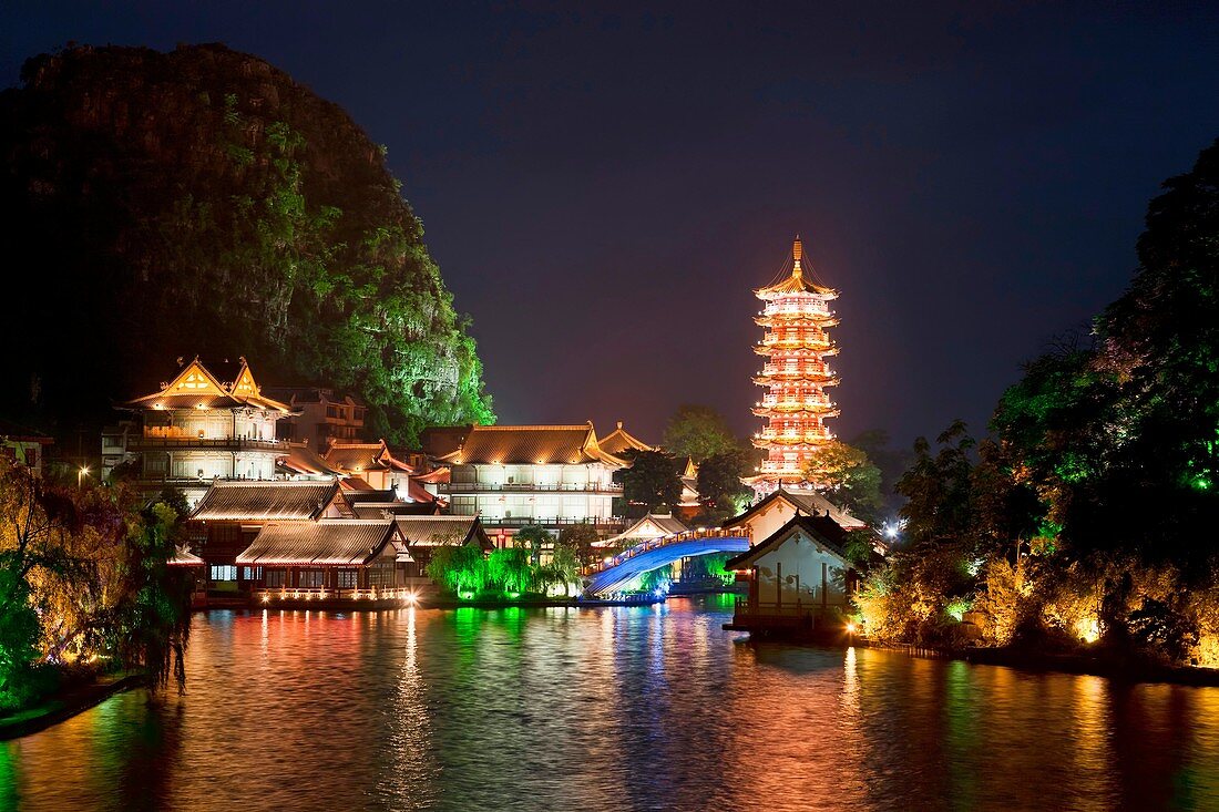 Mulong Pagoda also known as the Mulong Tower reflected in the Mulong Lake, Mulong Lake Park, Guilin, China