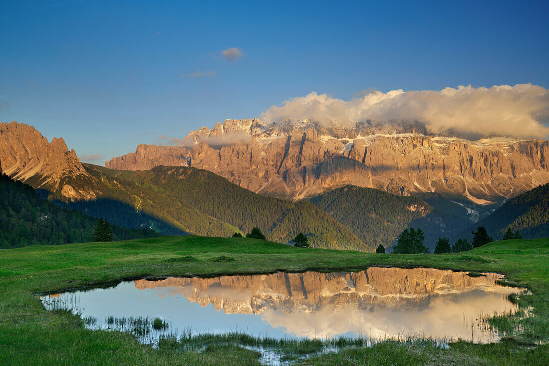 Sella range reflecting in a mountain lake, Val Gardena, Dolomites, UNESCO world heritage site Dolomites, South Tyrol, Italy