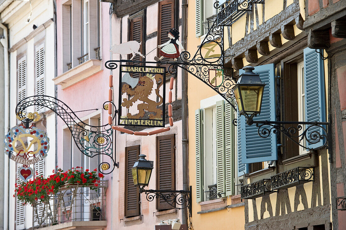 Colourful half timbered houses with decorative wrought-iron signs, Petite Venise, Colmar, Alsace, France