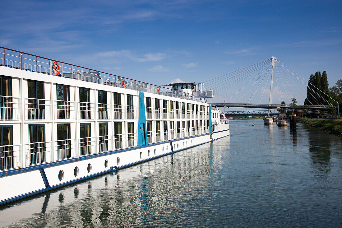 Rhine river cruise ship MS Bellevue and Passerelle des deux Rives pedestrian and cyclist bridge over Rhine river linking Strasbourg in France and Kehl in Germany, Kehl, Baden-Wurttemberg, Germany, Europe