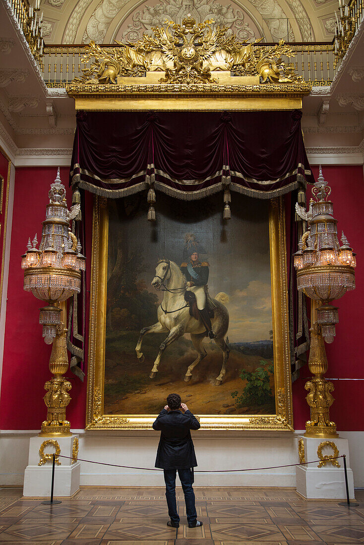 Man photographing painting inside The Hermitage museum complex, St. Petersburg, Russia, Europe