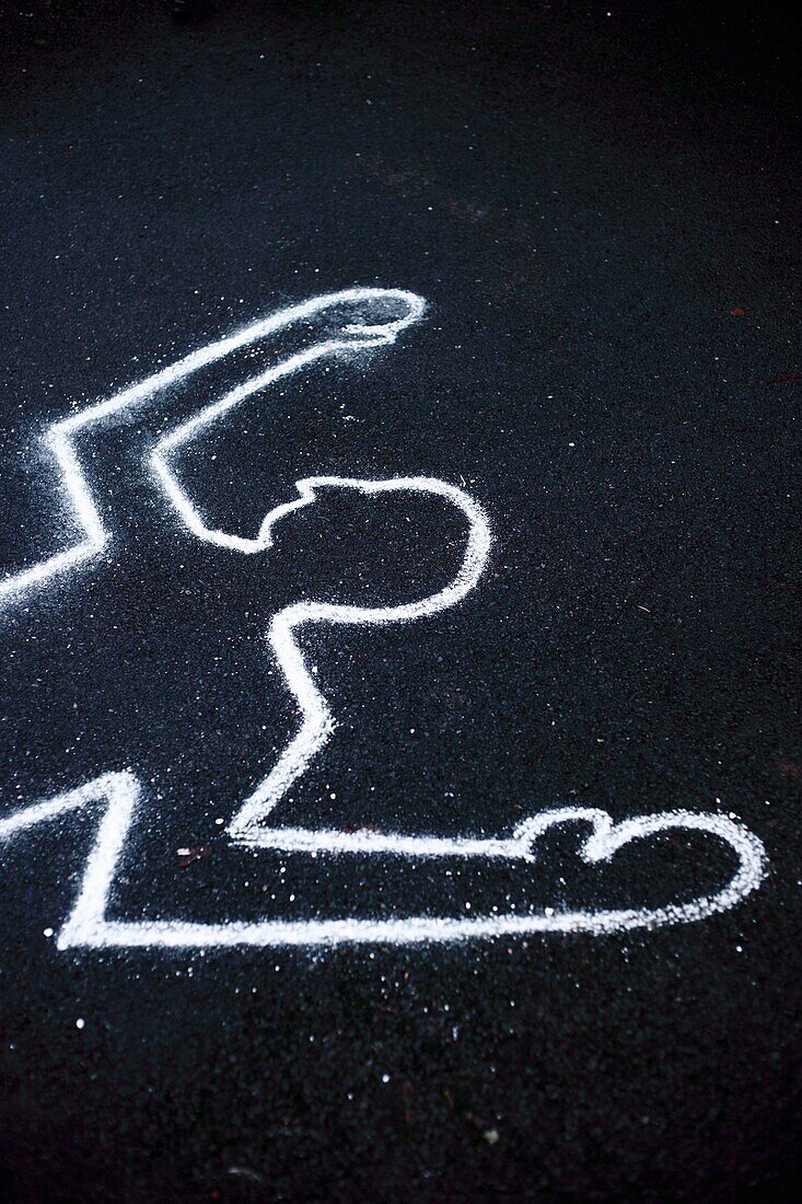 A chalk outline of a body on the ground as if at a crime scene.