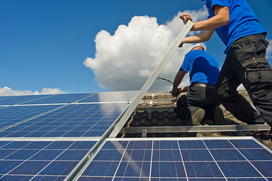 Two persons installing a solar plant, Freiburg im Breisgau, Black Forest, Baden-Wuerttemberg, Germany, Europe