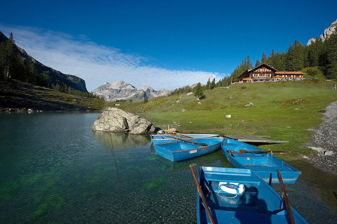 Rowing boats and guesthouse at lake Oeschinensee, Kandersteg, Bernese Oberland, Canton of Bern, Switzerland, Europe