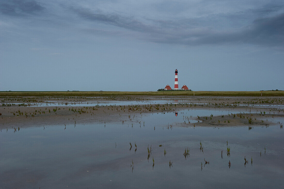 View over mudflats onto Westerheversand lighthouse, Westerhever, Wadden Sea National Park, Eiderstedt peninsula, North Frisian Islands, Schleswig-Holstein, Germany, Europe