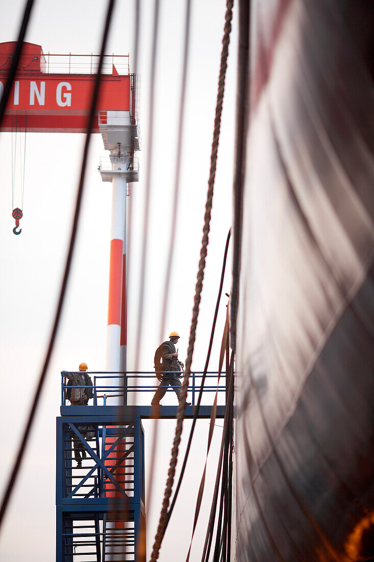 Chinese workers entering a frighter via scaffold steps, Ouhua Shipyard at Zhoushan, Zhejiang province, China