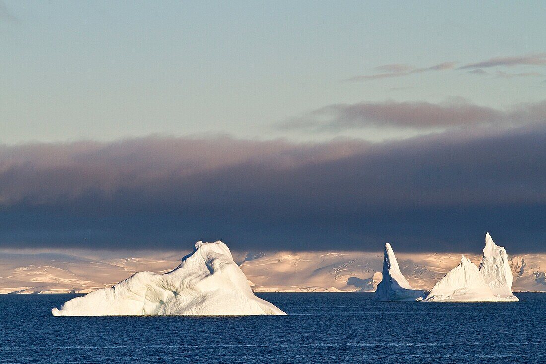 Early morning light catches icebergs in Neko Harbor on the western side of the Antarctic Peninsula during the summer months, Southern Ocean. Early morning light catches icebergs in Neko Harbor on the western side of the Antarctic Peninsula during the summ