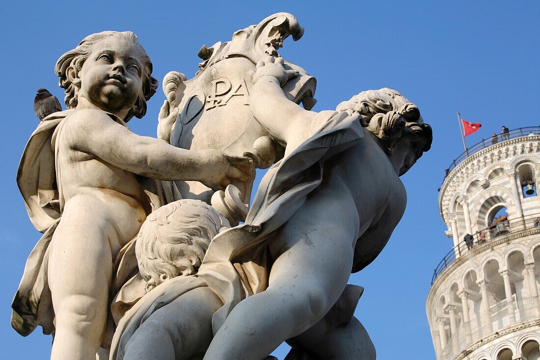 Cherubs holding shield bearing with the leaning tower behind, Pisa, Italy