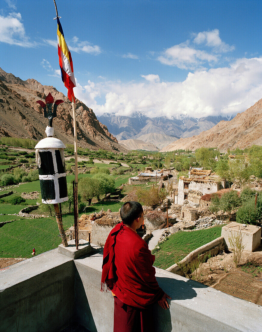 Monk on the rooftop of convent Thagchokling, village Ney, west of Leh, Ladakh, Jammu and Kashmir, India