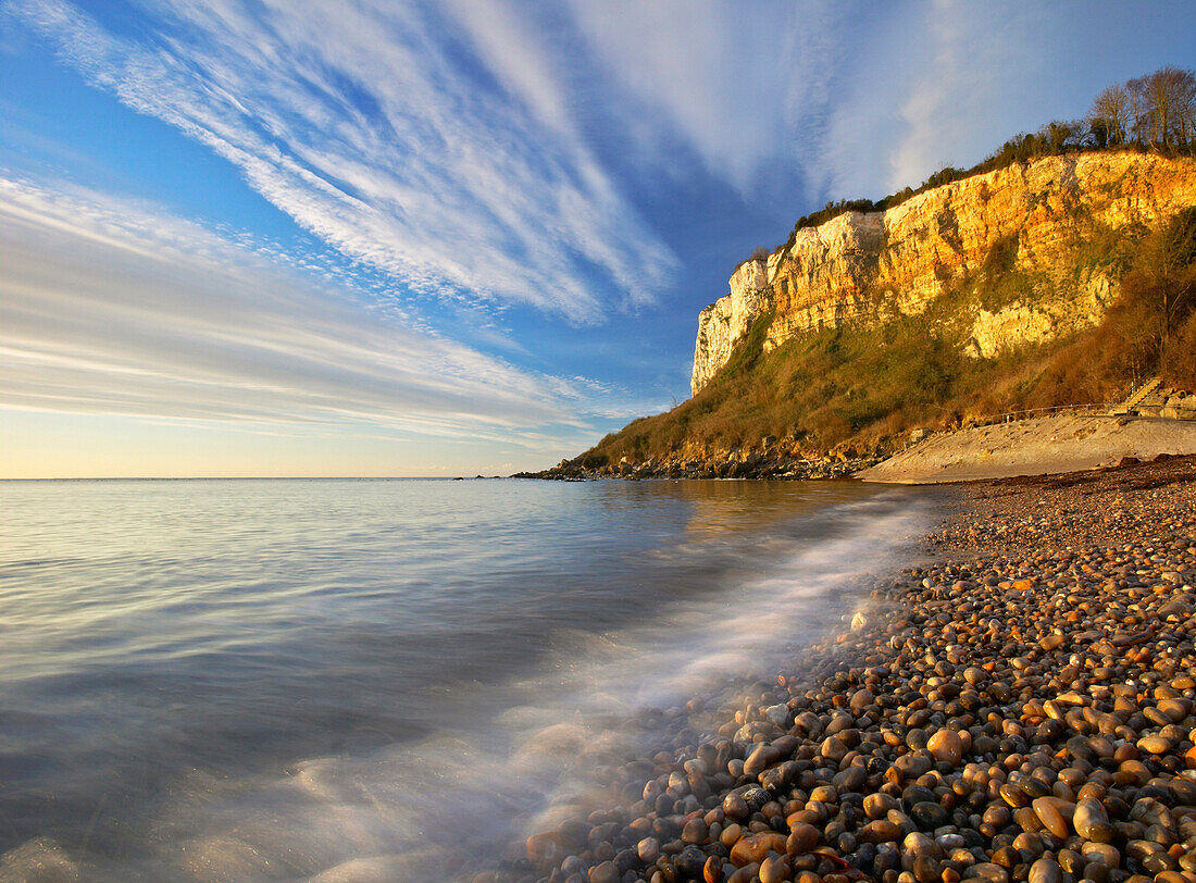 Shingle beach and red cliffs at Seaton hole, Jurassic Coast World Heritage Site, Devon, England, Great Britain